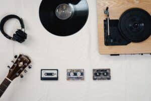 vinyl records and casette tapes on white table